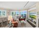 Open-concept living room featuring dining area, fireplace, leather furniture and ocean views at 1925 S Atlantic Ave # 201, Daytona Beach, FL 32118