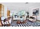 Features a sofa and two chairs with accent pillows and a rug at 1925 S Atlantic Ave # 201, Daytona Beach, FL 32118