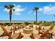 Outdoor community firepit with wooden chairs overlooking beach at 1925 S Atlantic Ave # 201, Daytona Beach, FL 32118