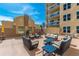 Features tan cushioned outdoor furniture with blue accent tables at 1925 S Atlantic Ave # 201, Daytona Beach, FL 32118