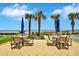 Features seating beneath umbrellas with beach access at 1925 S Atlantic Ave # 201, Daytona Beach, FL 32118