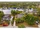 Waterfront home featuring a private pool, screened-in lanai, mature trees, and lush landscaping at 1957 Monterey Dr, Deltona, FL 32738