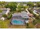 An aerial view of a home with a screened-in pool and well-maintained landscaping at 1957 Monterey Dr, Deltona, FL 32738
