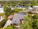 Aerial view of home featuring a screened pool, carport, and picturesque lake backdrop at 1957 Monterey Dr, Deltona, FL 32738