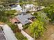 Aerial view of home featuring a screened pool, carport, and mature trees at 1957 Monterey Dr, Deltona, FL 32738