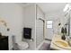 Bright bathroom featuring a dual sink vanity, tiled floors, and shower with a decorative curtain at 1957 Monterey Dr, Deltona, FL 32738