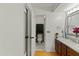 Bathroom featuring a dual sink vanity with wood cabinetry, tiled floors, and doorway to toilet at 1957 Monterey Dr, Deltona, FL 32738