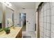 Well-lit bathroom featuring a vanity with double sinks and a framed mirror at 1957 Monterey Dr, Deltona, FL 32738