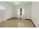 Cozy bedroom with tile flooring, natural light from two windows, and calming green ceiling at 1957 Monterey Dr, Deltona, FL 32738