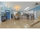 Well-lit dining area featuring tile flooring, chandelier, and open access to a modern kitchen and living area at 1957 Monterey Dr, Deltona, FL 32738