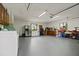 Spacious garage features washer, dryer, refrigerator, and storage cabinets at 1957 Monterey Dr, Deltona, FL 32738