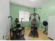 Home gym with exercise equipment, tiled floors, and a window for natural light at 1957 Monterey Dr, Deltona, FL 32738