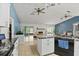 Open concept kitchen with tile flooring, island, and seamless flow to the living area at 1957 Monterey Dr, Deltona, FL 32738