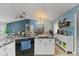 Bright kitchen with granite countertops, black appliances, and island seating at 1957 Monterey Dr, Deltona, FL 32738