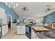 Bright, open floor plan featuring a large cooktop island, stainless appliances, and access to living area at 1957 Monterey Dr, Deltona, FL 32738