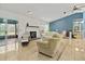 Spacious living room features bright neutral decor, fireplace, and tiled floor at 1957 Monterey Dr, Deltona, FL 32738