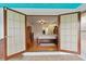 Open doorway leading into a luxurious main bedroom with hardwood floors and detailed furnishings at 1957 Monterey Dr, Deltona, FL 32738