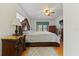 Luxurious main bedroom featuring hardwood floors, a king bed, and screened in porch at 1957 Monterey Dr, Deltona, FL 32738