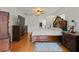 Luxurious main bedroom featuring hardwood floors, a king bed, and detailed wood furnishings at 1957 Monterey Dr, Deltona, FL 32738