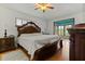 Luxurious main bedroom featuring hardwood floors, a king bed, and screened in porch at 1957 Monterey Dr, Deltona, FL 32738