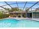 Exterior view of screened-in pool with outdoor grill at 1957 Monterey Dr, Deltona, FL 32738