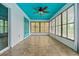 Bright sunroom features neutral tile flooring, a turquoise ceiling and door, and multiple windows at 1957 Monterey Dr, Deltona, FL 32738