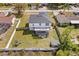 Aerial view of a home with a spacious backyard, screened-in porch, fenced yard and mature trees at 1978 S Old Mill Dr, Deltona, FL 32725