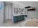 Bright bathroom with double vanity, garden tub, decorative mirrors, and tiled floors at 1978 S Old Mill Dr, Deltona, FL 32725