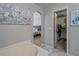 Bathroom featuring tub and a doorway leading into a bedroom with a walk-in closet at 1978 S Old Mill Dr, Deltona, FL 32725