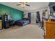 Spacious bedroom with a modern ceiling fan, featuring a vibrant green accent wall and large window at 1978 S Old Mill Dr, Deltona, FL 32725