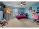 Bright bedroom featuring colorful decor, a ceiling fan, and ample natural light, creating a cheerful ambiance at 1978 S Old Mill Dr, Deltona, FL 32725
