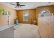 Spacious bonus room with a ceiling fan, neutral carpet, and plenty of natural light at 1978 S Old Mill Dr, Deltona, FL 32725