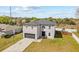 View of the two-story home with a well-kept lawn and mature landscaping at 1978 S Old Mill Dr, Deltona, FL 32725