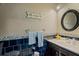 Stylish half bathroom featuring blue accents, unique mosaic tile, and modern fixtures at 1978 S Old Mill Dr, Deltona, FL 32725