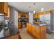 Modern kitchen with wood cabinets, granite counters, stainless appliances, and an island for additional workspace at 1978 S Old Mill Dr, Deltona, FL 32725