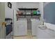 Functional laundry room with a washer, dryer, and shelving, providing convenient space for laundry tasks at 1978 S Old Mill Dr, Deltona, FL 32725