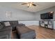 Relaxing living room showcasing a gray sectional, a flat-screen TV, and hardwood flooring at 1978 S Old Mill Dr, Deltona, FL 32725