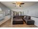 Spacious living room flowing into the kitchen, featuring a large gray sectional and hardwood floors at 1978 S Old Mill Dr, Deltona, FL 32725