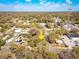 Aerial view of a neighborhood featuring a mix of homes, trees, and a prominent yellow arrow at 201 W Central Ave, Orange City, FL 32763