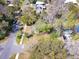 Aerial view of a home featuring mature shade trees, a yard, and street access at 201 W Central Ave, Orange City, FL 32763