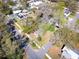 Aerial view of a home featuring mature shade trees, a yard, and street access at 201 W Central Ave, Orange City, FL 32763