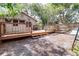 Exterior view of a back deck with brown railings, steps, a backyard, and partial hammock at 201 W Central Ave, Orange City, FL 32763