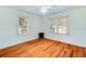 Bright bedroom with hardwood floors, two windows and a ceiling fan at 201 W Central Ave, Orange City, FL 32763