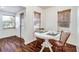 Cozy dining area featuring a round table, hardwood floors and two windows with natural light at 201 W Central Ave, Orange City, FL 32763