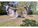 Charming home featuring light-colored siding, blue shutters, and flower boxes under the windows at 201 W Central Ave, Orange City, FL 32763