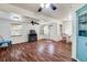 Bright living room with hardwood floors, a ceiling fan, and a fireplace at 201 W Central Ave, Orange City, FL 32763