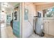 Mud room with water heater, electrical panel, and access to kitchen at 201 W Central Ave, Orange City, FL 32763