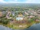 Beautiful aerial view of a community pool surrounded by lush trees, walkways, and residential properties at 203 W Tarrington Dr, Deland, FL 32724