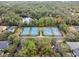 Aerial view of the community tennis courts, adjacent to a parking lot and residential properties at 203 W Tarrington Dr, Deland, FL 32724