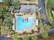 Aerial close up of the community pool and clubhouse with plenty of seating and a parking lot at 203 W Tarrington Dr, Deland, FL 32724
